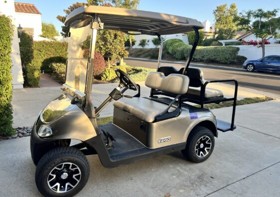 Residents using golf cart inside Ocean Hills community