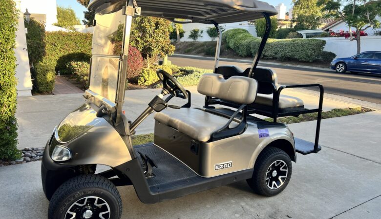 Residents using golf cart inside Ocean Hills community