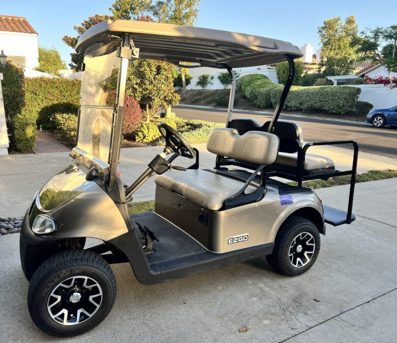Residents using golf cart inside Ocean Hills community